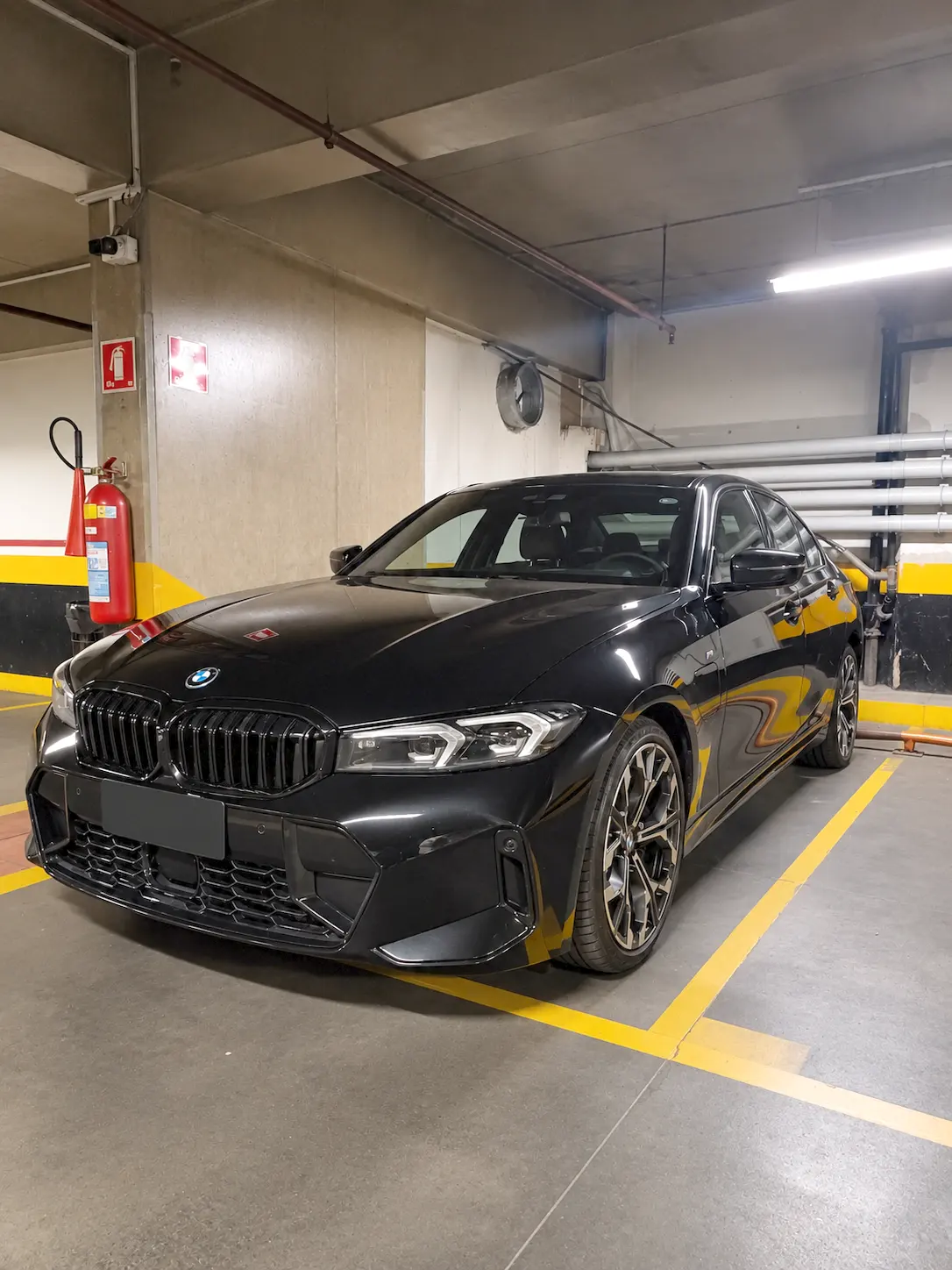 Black BMW executive sedan parked in a garage