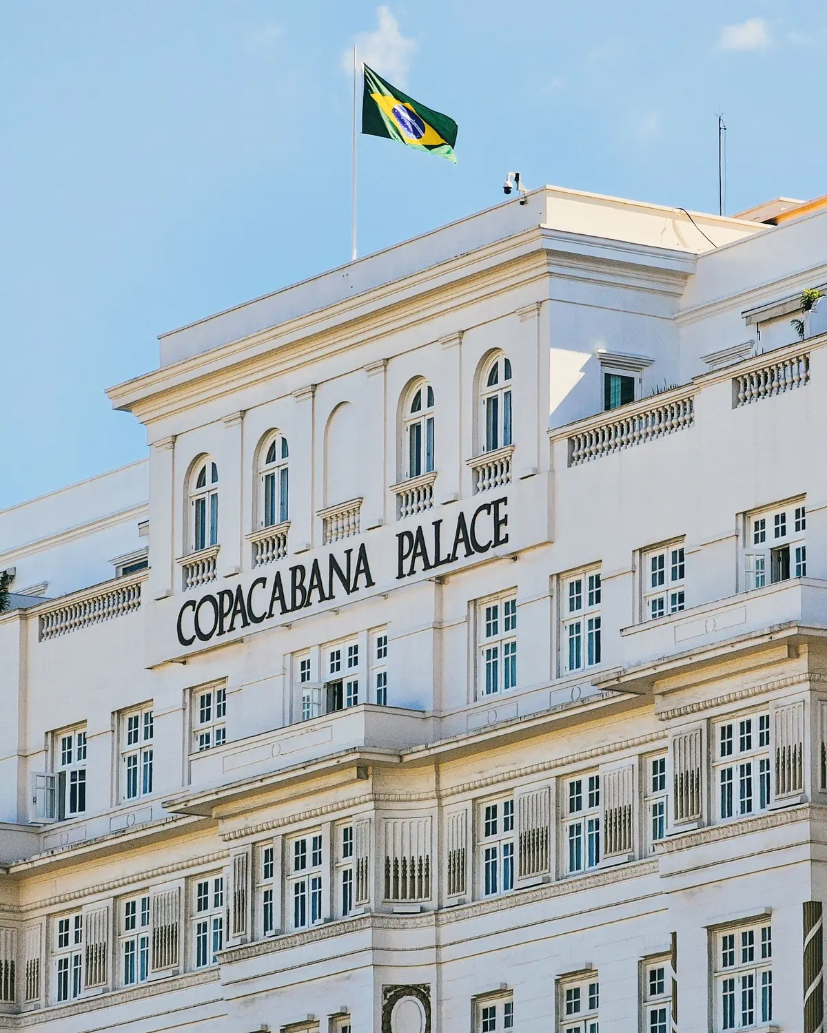 Classic façade of the Copacabana Palace hotel in Rio de Janeiro, with the Brazilian flag